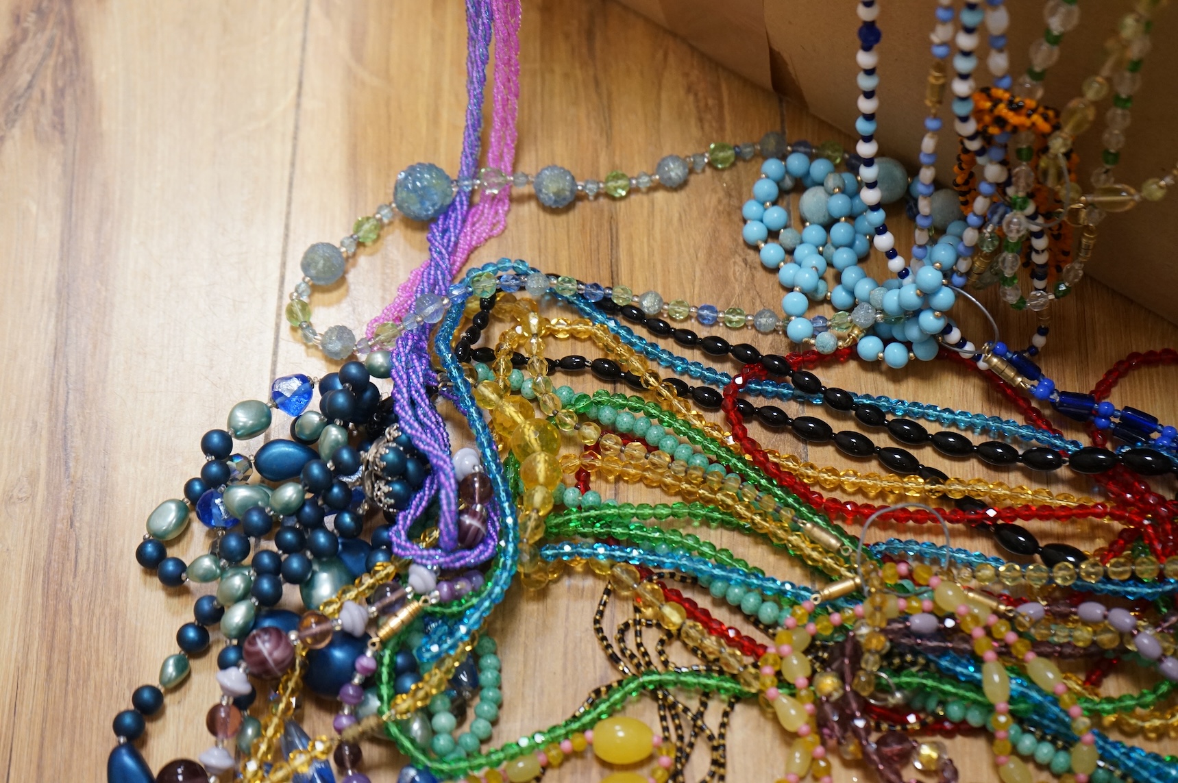 A large collection of glass bead necklaces